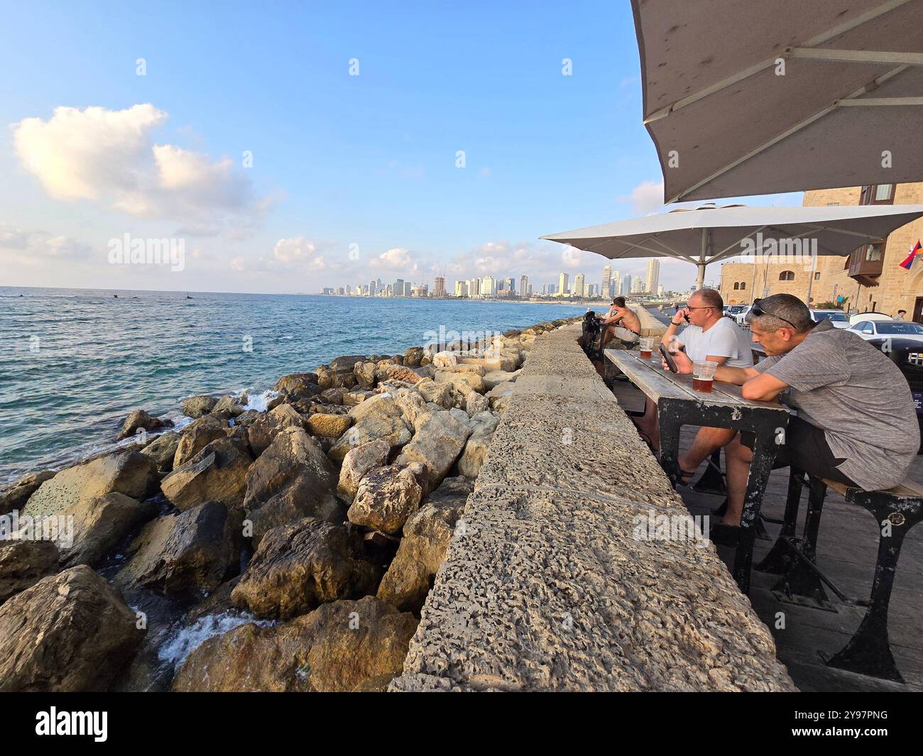 Relaxing by the sea with a beautiful view of Tel-Aviv. Jaffa, Israel. - Smartphone Captured Stock Image