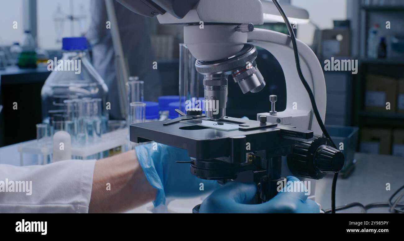 Drug Testing Microscope Scientist putting sample under microscope hi-res stock photography and ...