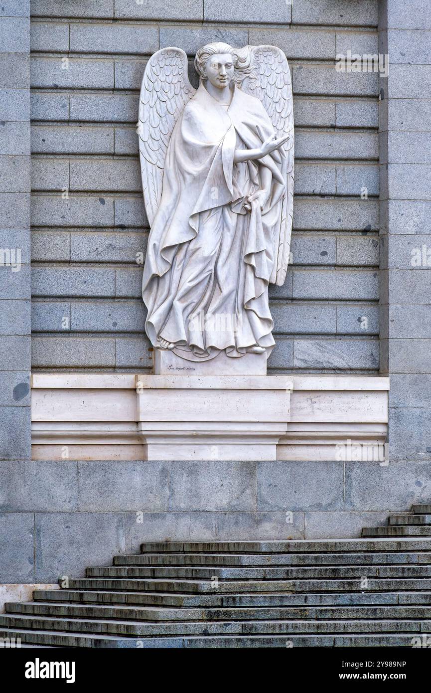 Sculpture of a religious angel on the facade of Almudena Cathedral ...