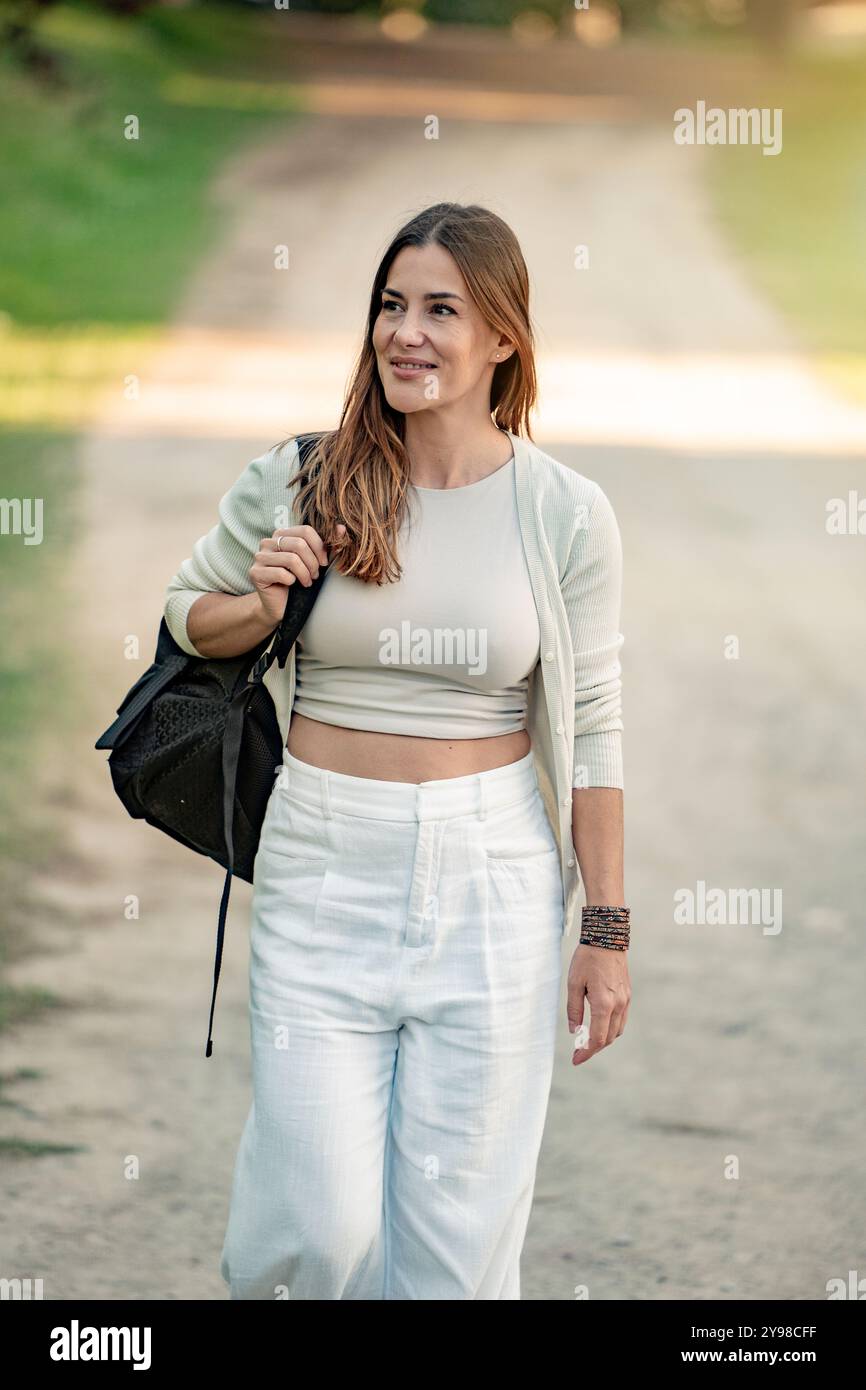Adult female carrying backpack walks hi-res stock photography and ...