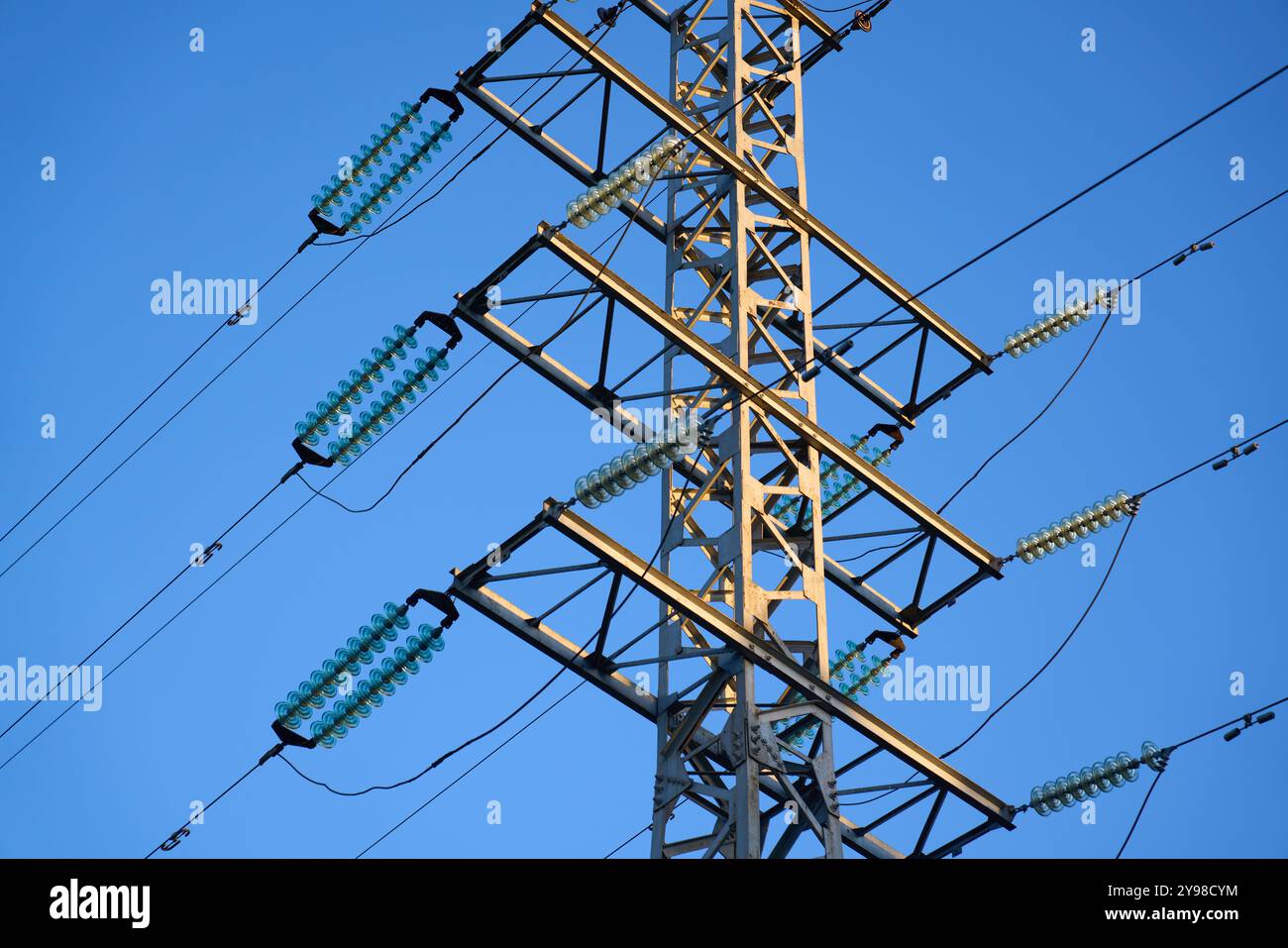 High voltage towers aganist the blue sky background Stock Photo - Alamy
