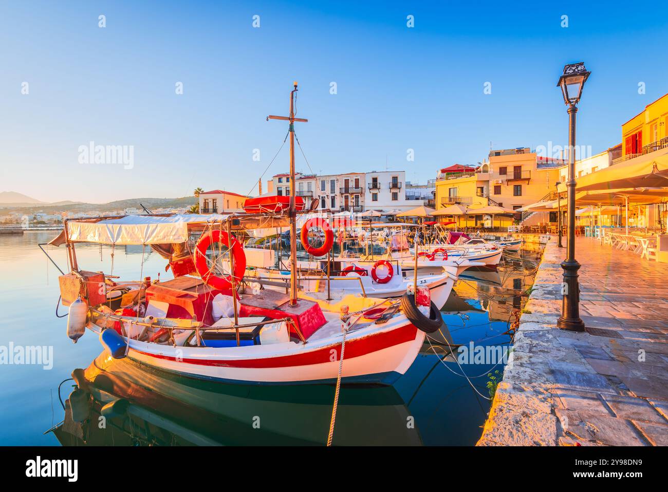 Rethymno, Greece. Beautiful city of Crete, Greek Islands, with Venetian Harbor and fishermen boats at sunrise. Stock Photo