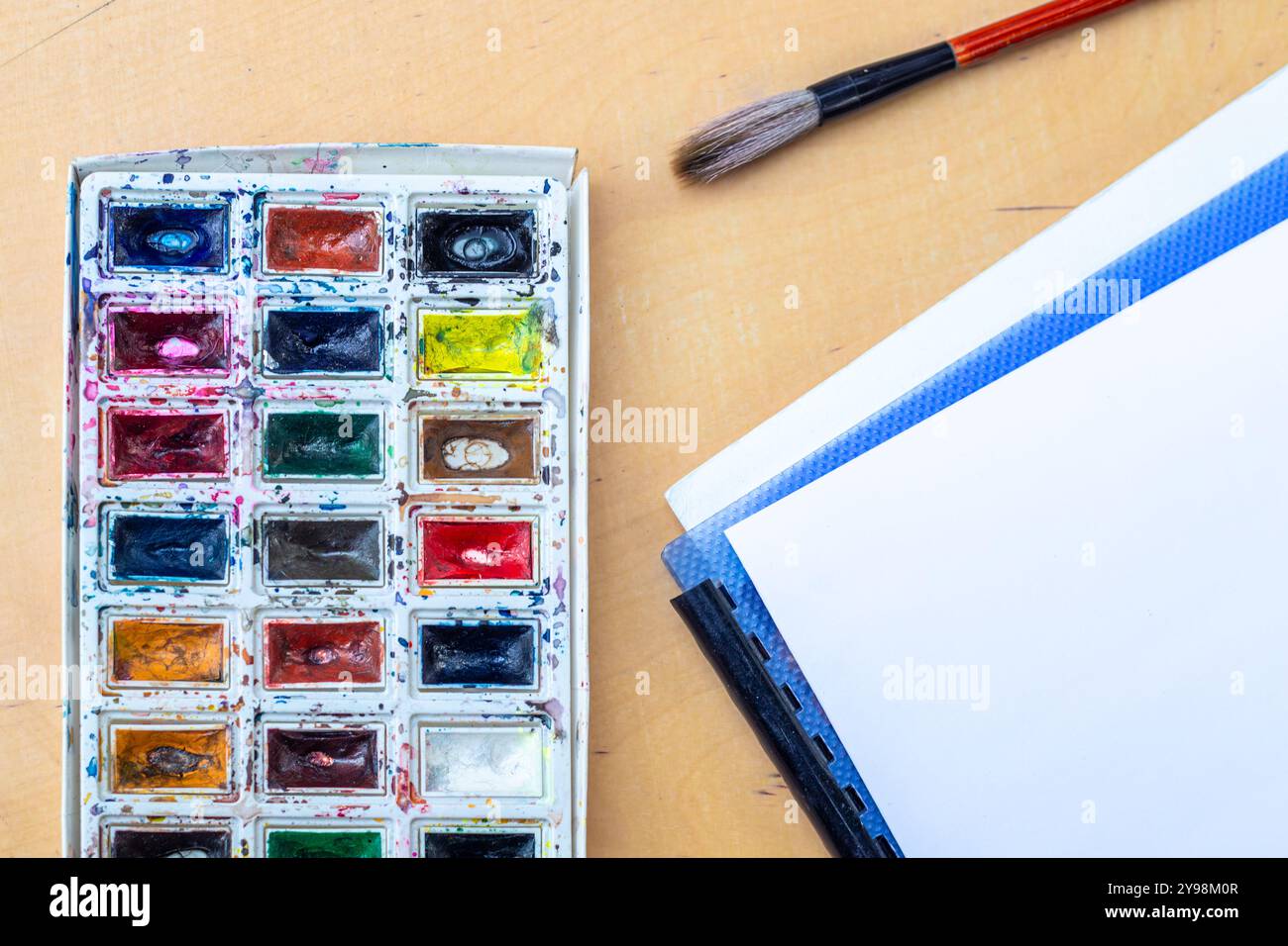 Palette with watercolors. A palette with watercolors and paint brush ...