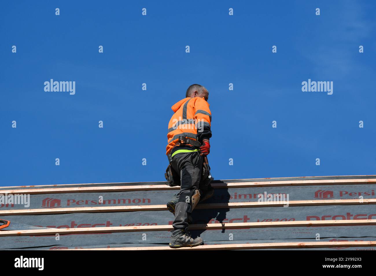 man working on a roof Stock Photo