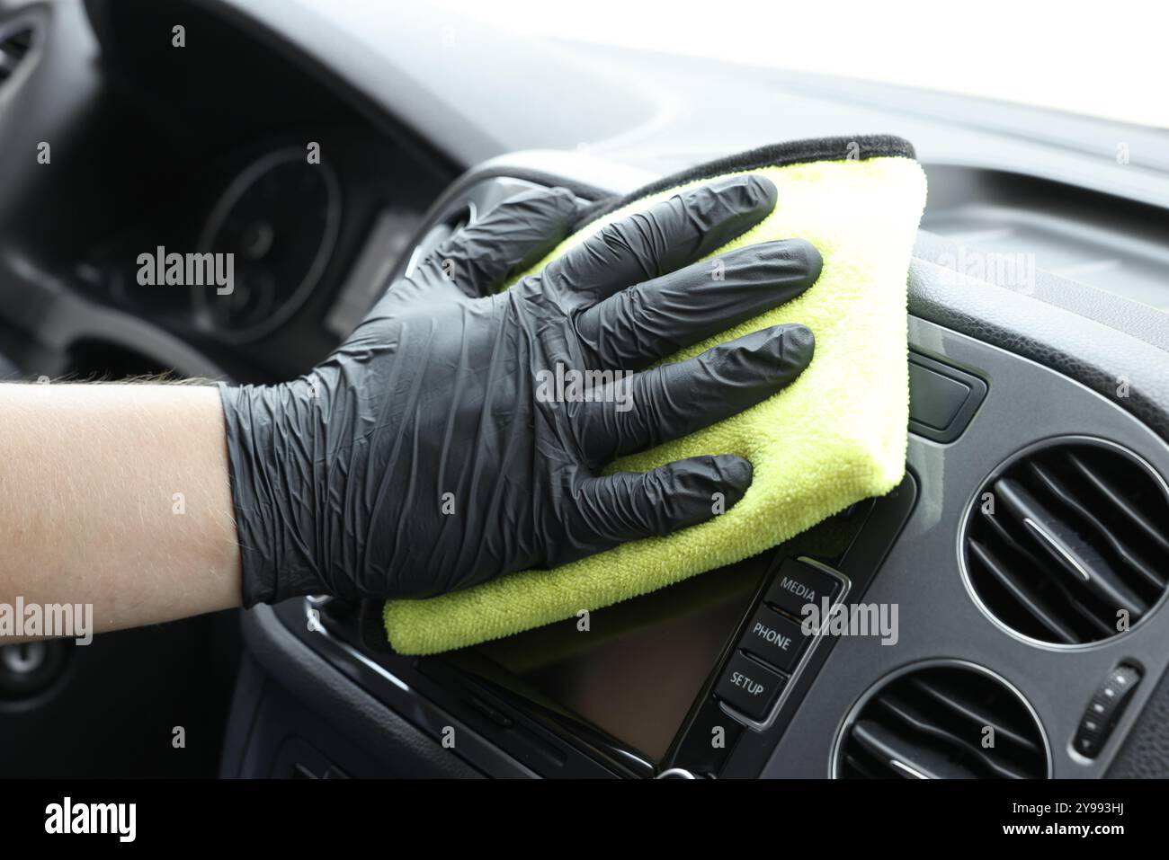 Man cleaning center console with rag, closeup Stock Photo - Alamy