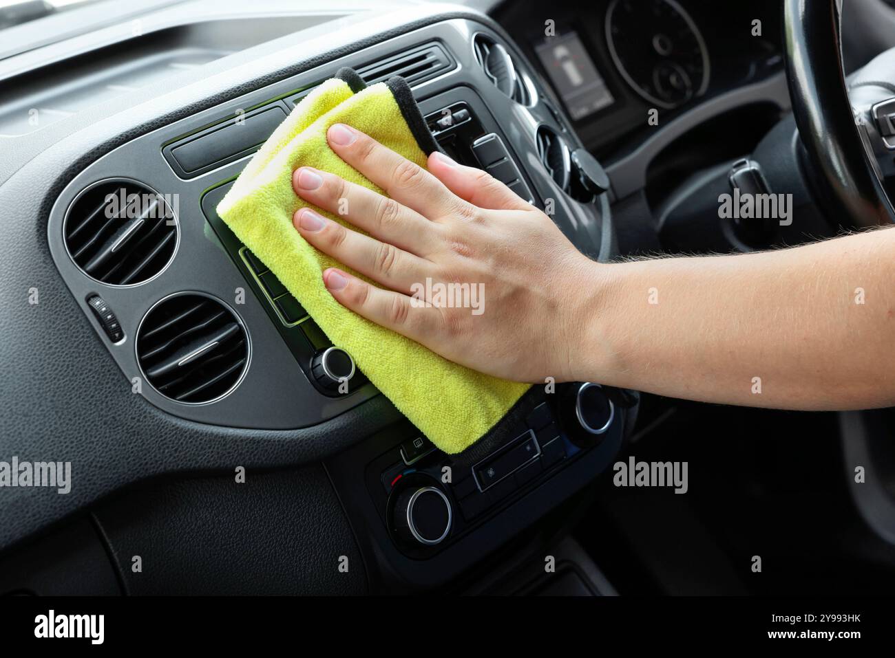 Man cleaning center console with rag, closeup Stock Photo - Alamy