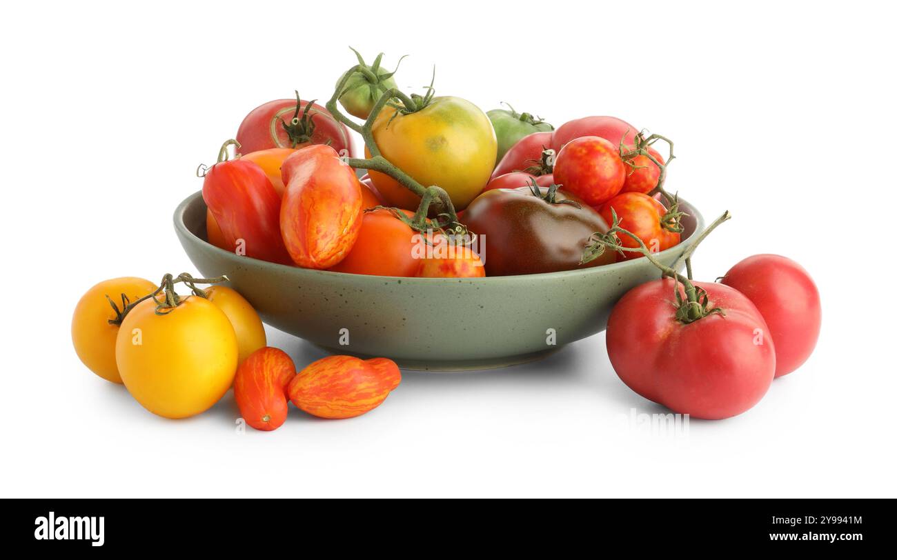 Different ripe tomatoes in bowl isolated on white Stock Photo - Alamy