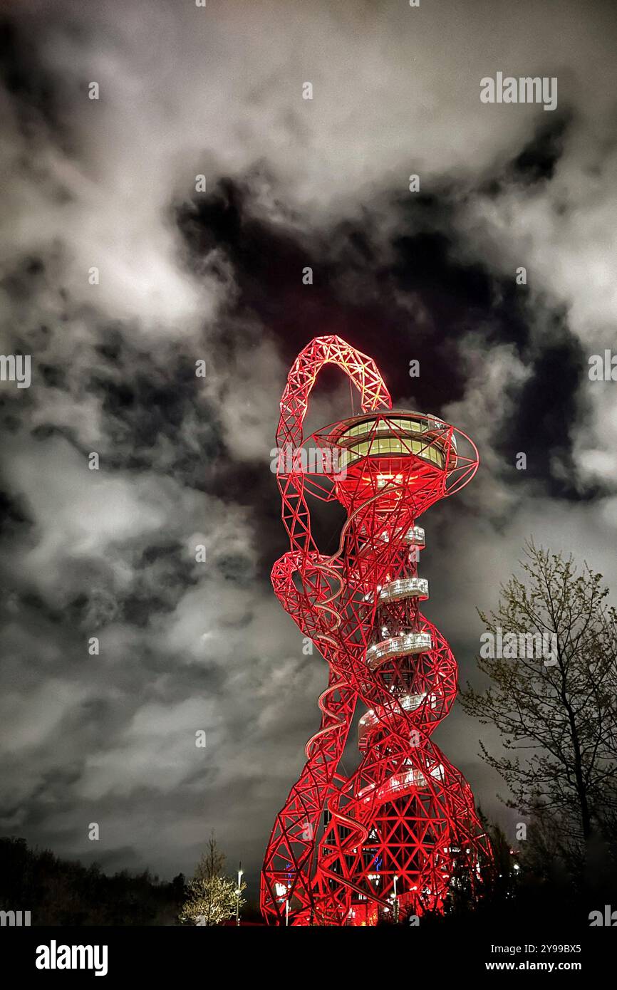 ArcelorMittal Orbit lit up at night against a cloudy sky in Queen Elizabeth Olympic Park, Stratford. London, UK Stock Photo