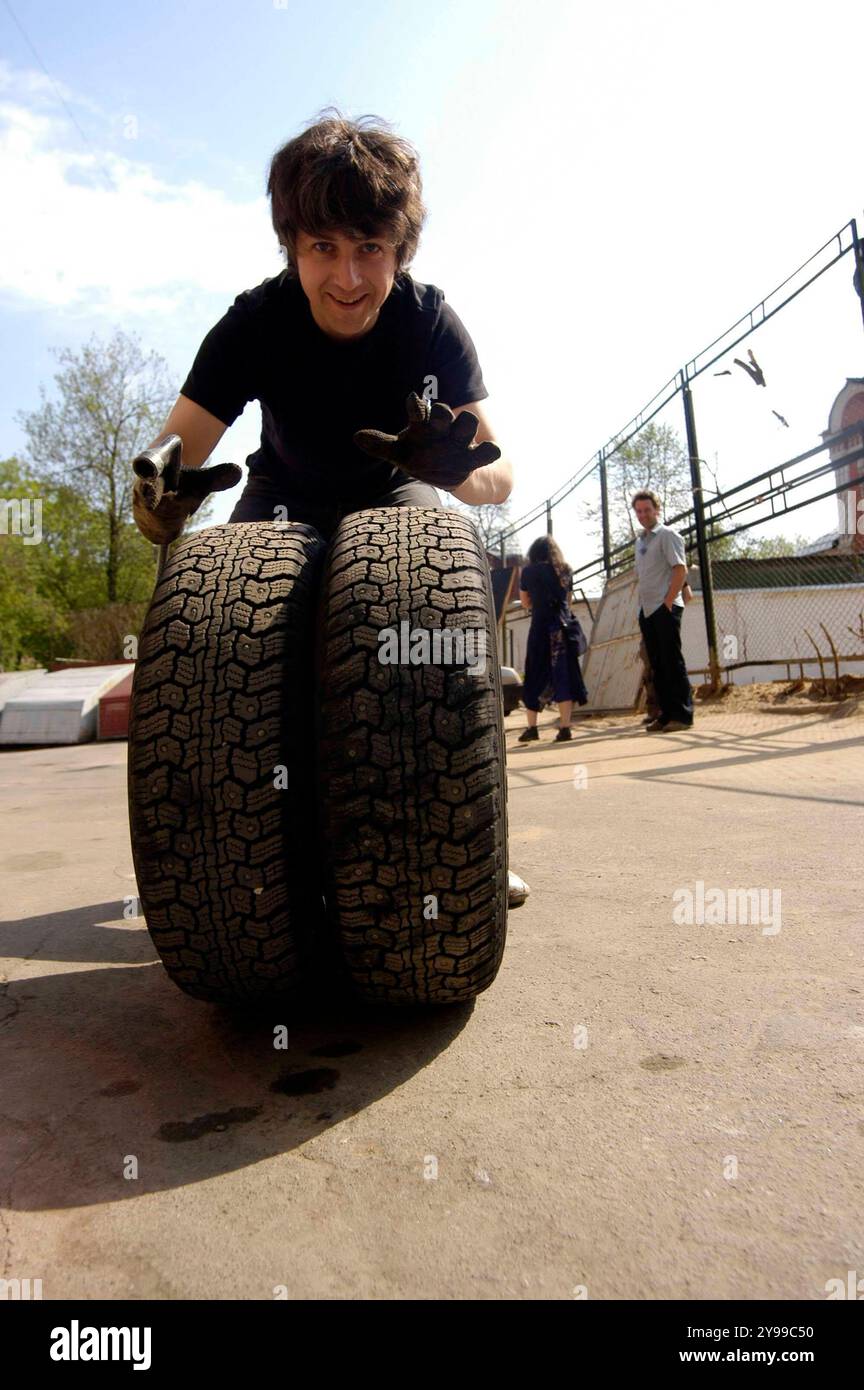 employee at the car shop manually changing tire on a vehicle manually changing tires on a car Stock Photo