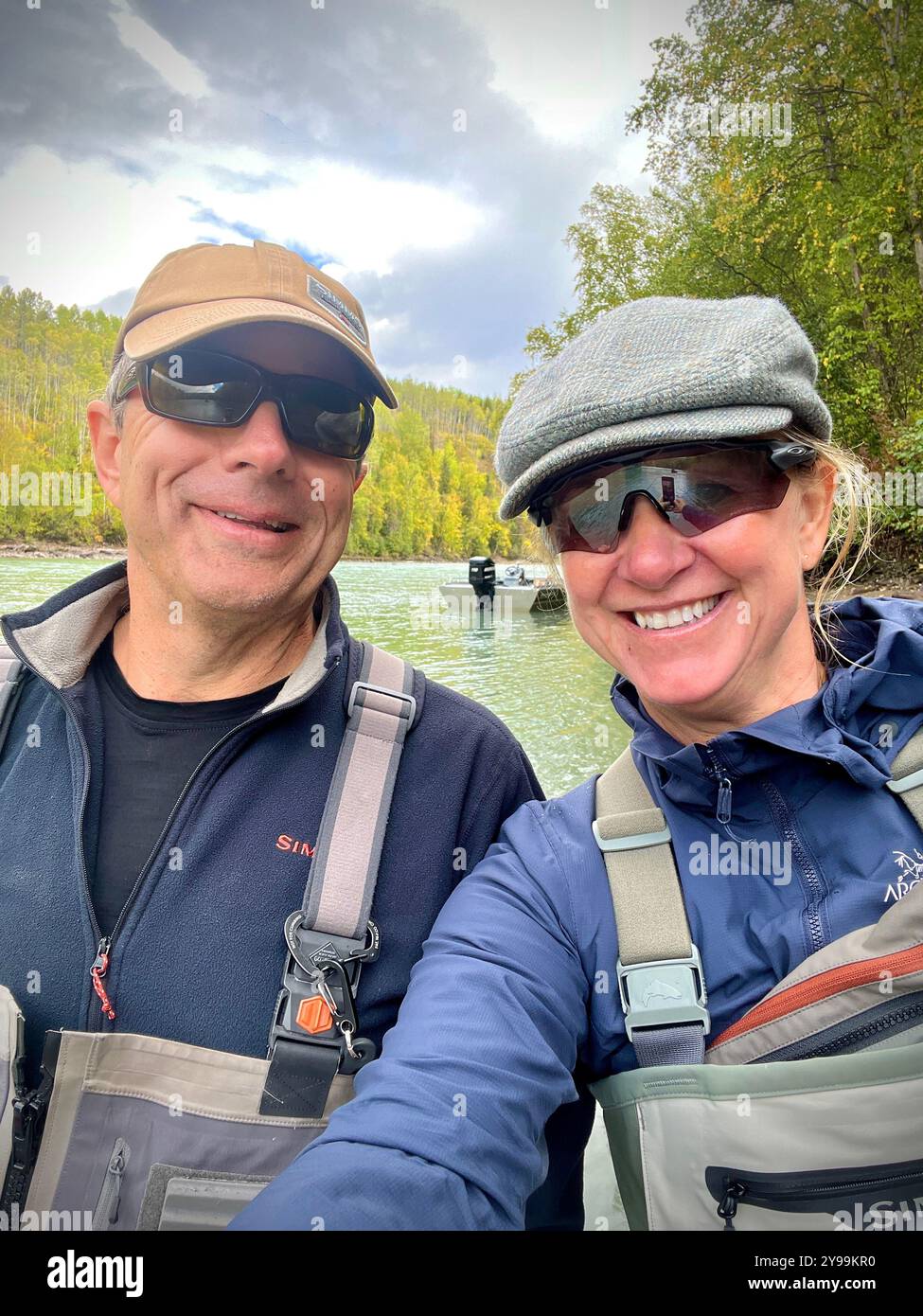 A couple enjoying a day of steelhead fishing on the Bulkley River, British Columbia, surrounded by the stunning fall scenery. - Smartphone Captured Stock Image