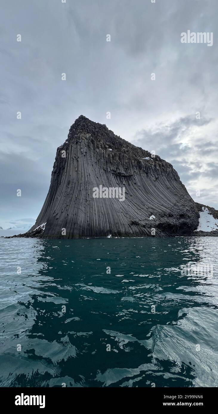 Edinburgh Rock, Antarctica: a towering geological wonder rising from icy waters, showcasing rugged beauty and untouched polar wilderness. - Smartphone Captured Stock Image