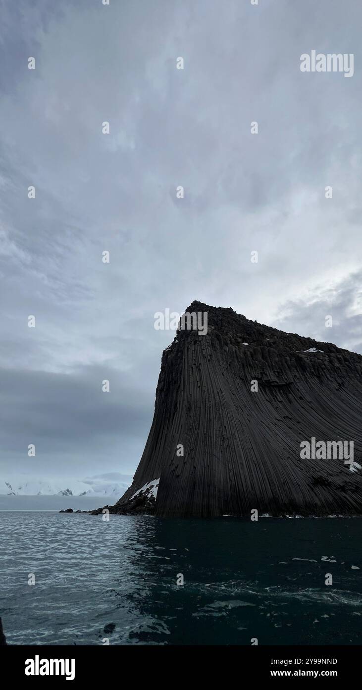 Edinburgh Rock, Antarctica: a towering geological wonder rising from icy waters, showcasing rugged beauty and untouched polar wilderness. - Smartphone Captured Stock Image
