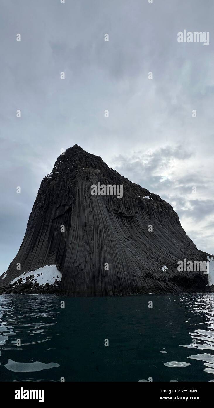 Edinburgh Rock, Antarctica: a towering geological wonder rising from icy waters, showcasing rugged beauty and untouched polar wilderness. - Smartphone Captured Stock Image