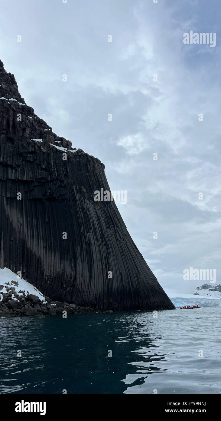 Edinburgh Rock, Antarctica: a towering geological wonder rising from icy waters, showcasing rugged beauty and untouched polar wilderness. - Smartphone Captured Stock Image