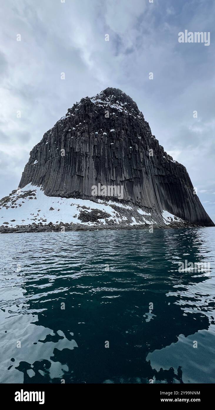 Edinburgh Rock, Antarctica: a towering geological wonder rising from icy waters, showcasing rugged beauty and untouched polar wilderness. - Smartphone Captured Stock Image