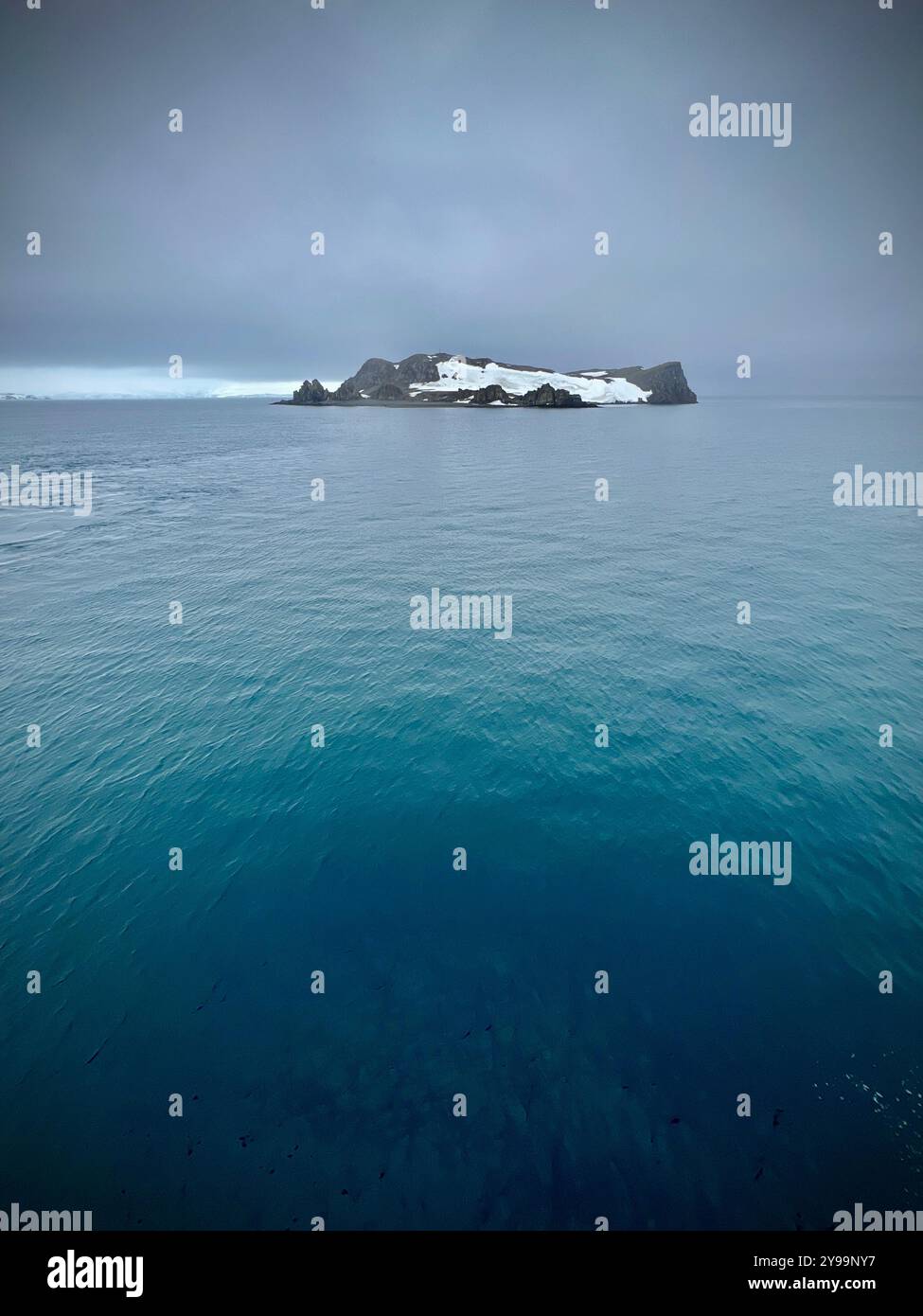 Edinburgh Rock, Antarctica: a towering geological wonder rising from icy waters, showcasing rugged beauty and untouched polar wilderness. - Smartphone Captured Stock Image