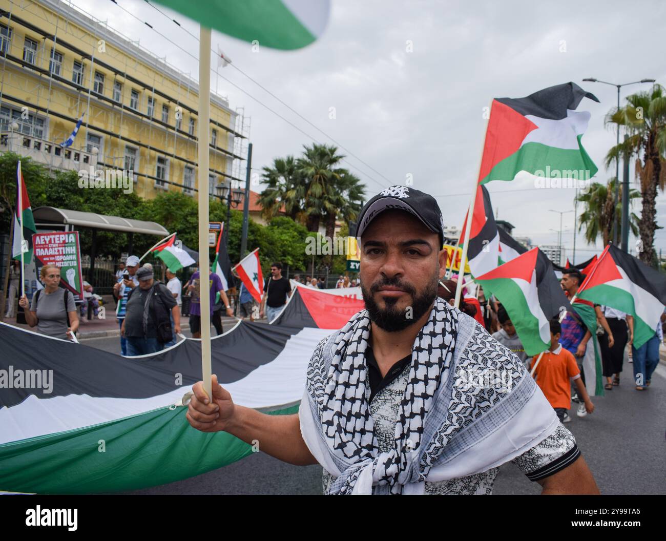 Athens, Greece. 05th Oct, 2024. Demonstrators hold a giant Palestine flag and shout slogans. Hundreds of protesters marched in the streets of Athens against wars and in solidarity with Lebanon and Palestine, in Greece, on October 5, 2024. (Photo by Dimitris Aspiotis/Pacific Press/Sipa USA) Credit: Sipa USA/Alamy Live News Stock Photo