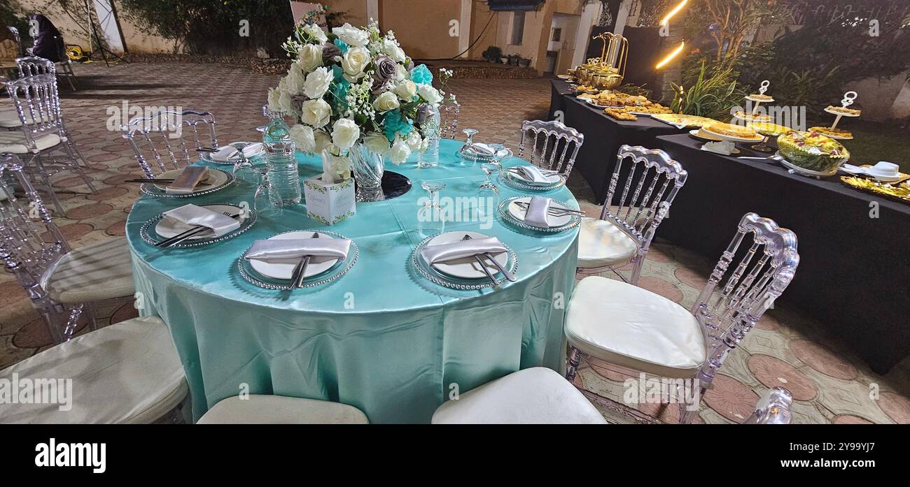 Table setup for a special occasion, decorated with color arranged flowers - Smartphone Captured Stock Image