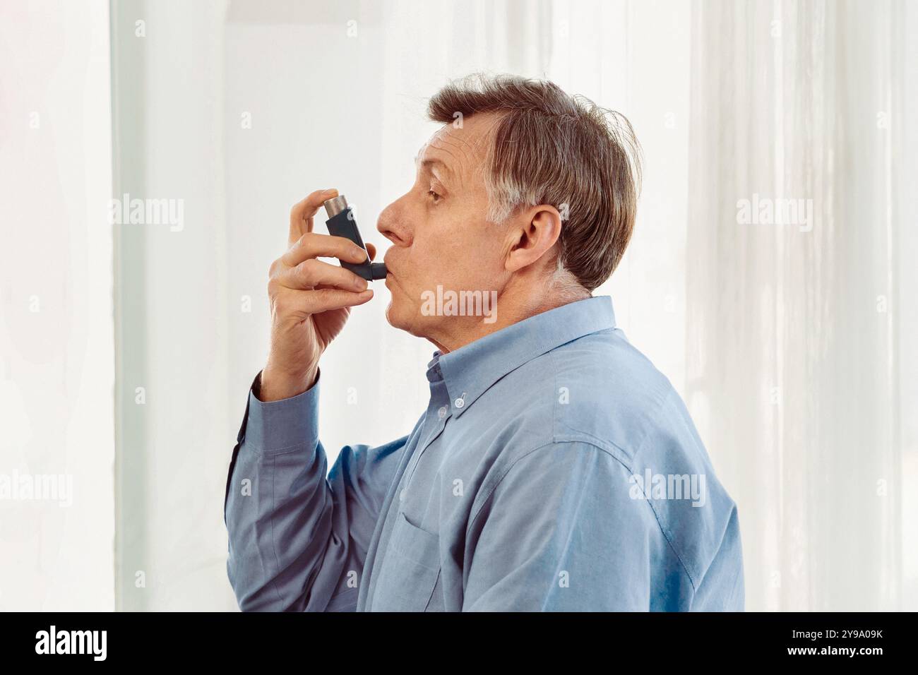 Someone Using Blue Inhaler Physician examining mature man using blue asthma inhaler Stock Photo ...