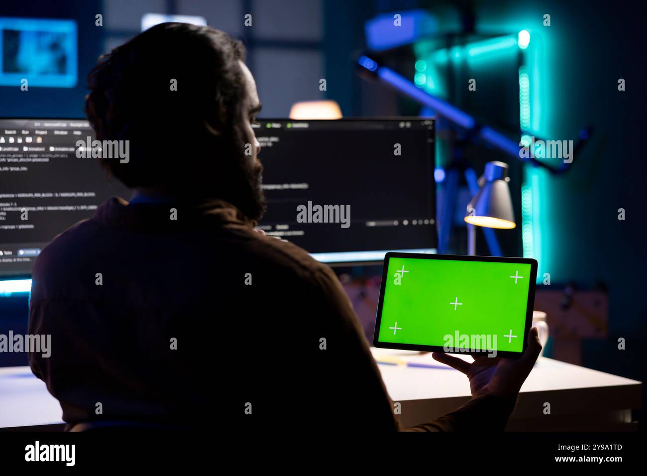 Developer using isolated screen tablet to implement security measures, protecting company systems and data. IT admin testing and debugging code for applications on mockup portable device Stock Photo