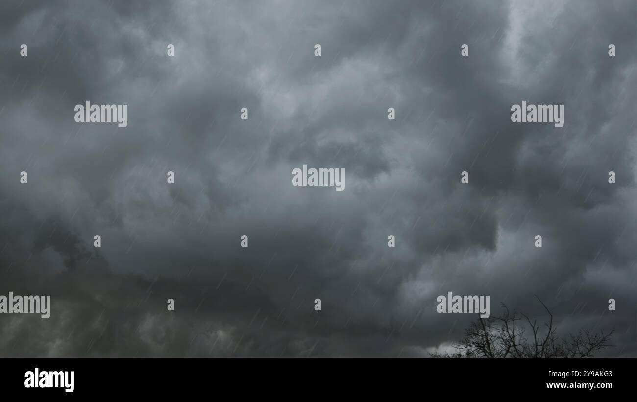Dramatic dark storm clouds and heavy rainfall Stock Photo
