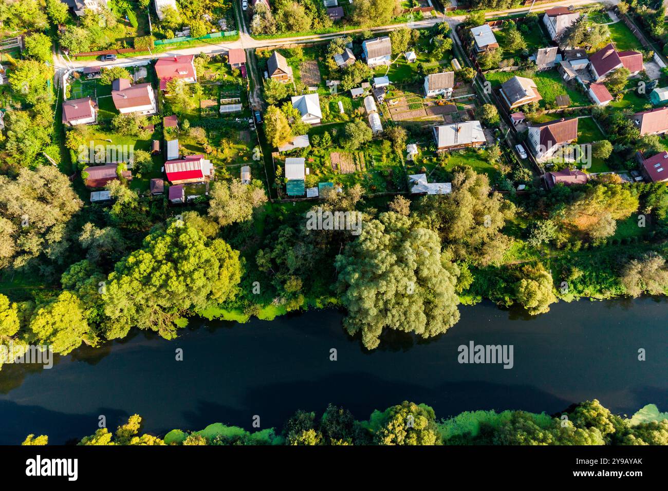 Colorful view of private development by the river, summer cottages in a ...