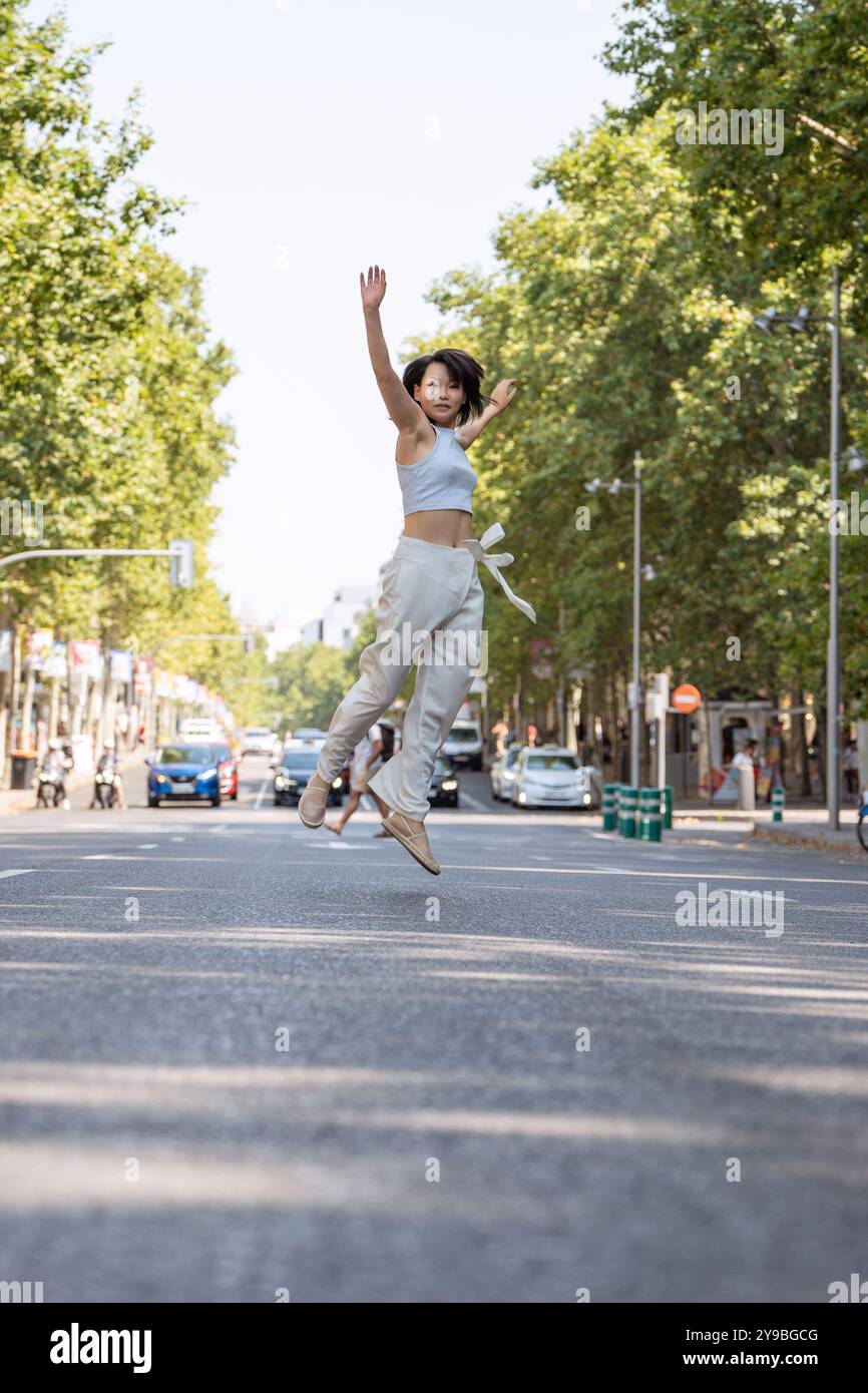 Young asian woman jumps joy hi-res stock photography and images - Alamy