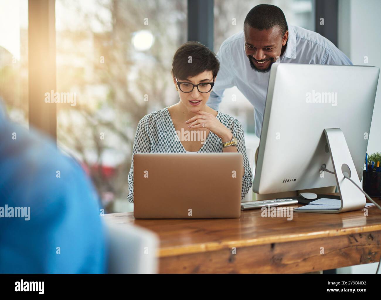 Business people, laptop and teamwork with cooperation, conversation and ...