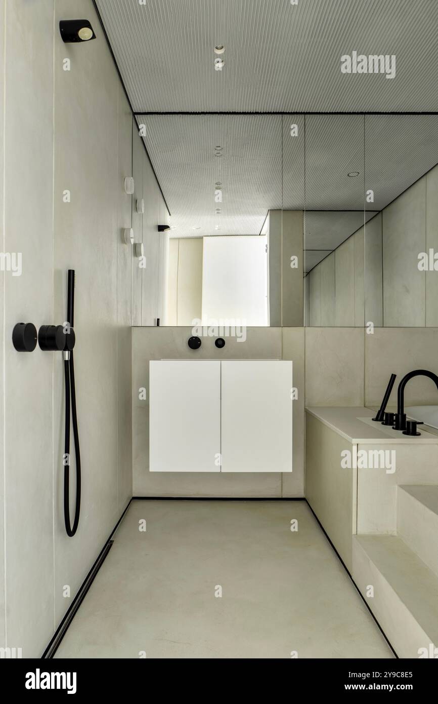 Modern minimalist bathrooms have sleek fixtures and elegant aesthetics to enhance ambiance Stock Photo