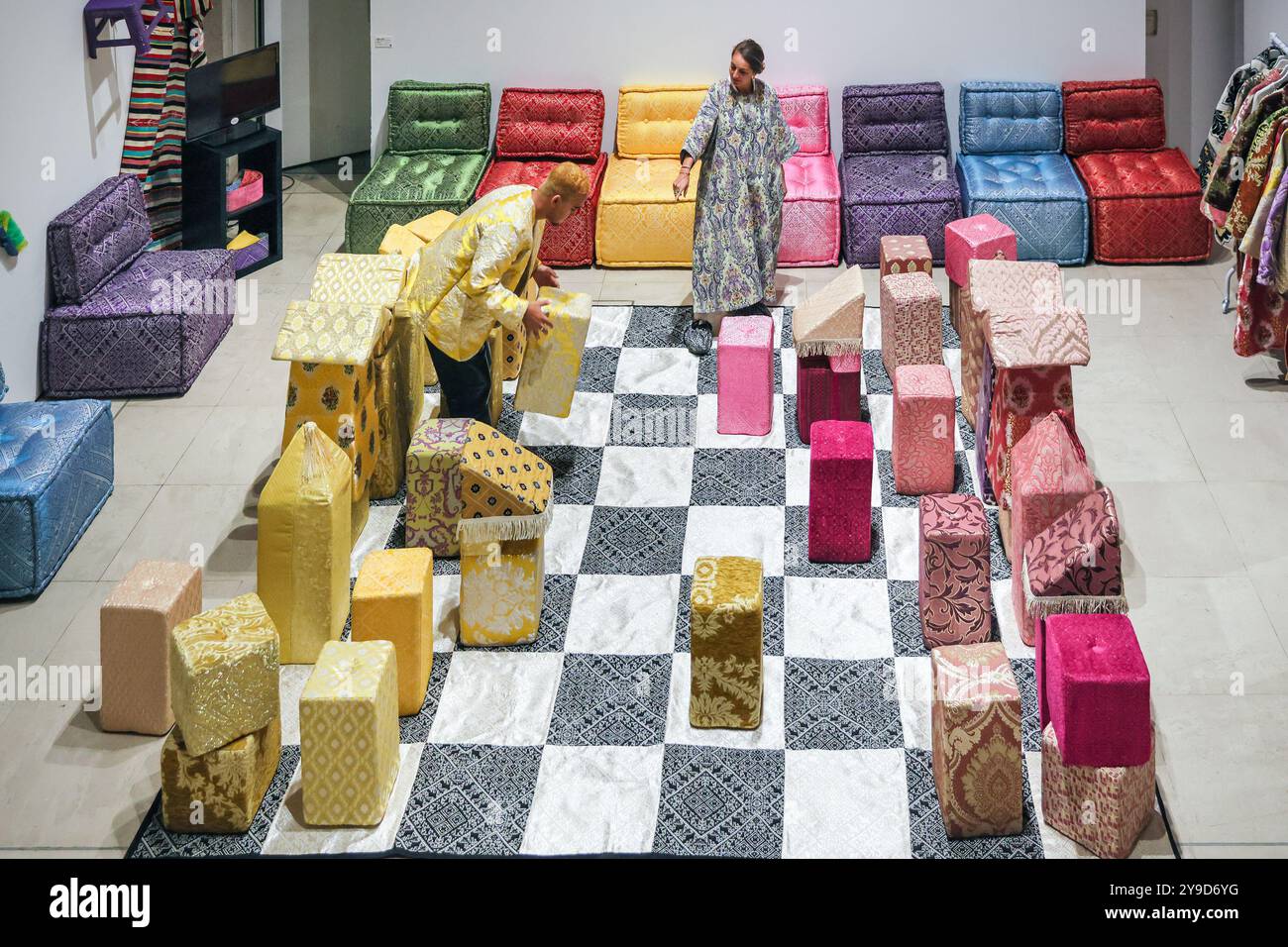 London, UK. 10th Oct 2024. Artist Sophia Kacimi, and photographer Osama (who created the integral imagery featured in the work) with the installation. The colourful centrepiece installation 'Play on Craft' by Sophia Kacimi and artisan friends, part of the Zoubida Project. The instsallation is a playful take inspired by Moroccan fabrics and everyday life, visitors are encourraged to interact with the giant chess board game. 1-54 Contemporary African Art Fair celebrates its 12th Edition at Somerset House with the special installation. Over 60 galleries and 160 artists from Africa and the diaspor Stock Photo