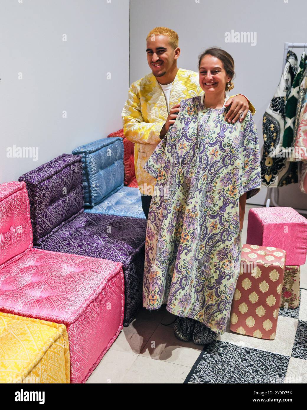 London, UK. 10th Oct 2024. Artist Sophia Kacimi, and photographer Osama (who created the integral imagery featured in the work) with the installation. The colourful centrepiece installation 'Play on Craft' by Sophia Kacimi and artisan friends, part of the Zoubida Project. The instsallation is a playful take inspired by Moroccan fabrics and everyday life, visitors are encourraged to interact with the giant chess board game. 1-54 Contemporary African Art Fair celebrates its 12th Edition at Somerset House with the special installation. Over 60 galleries and 160 artists from Africa and the diaspor Stock Photo