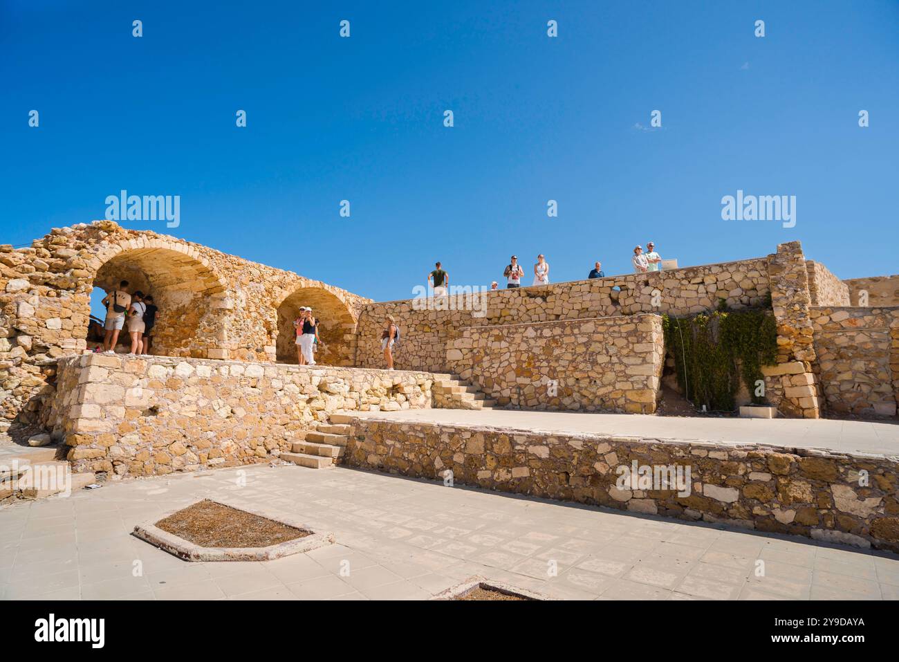 Venetian sea wall, view of tourists sightseeing on the historic sea wall that encloses the Venetian old town harbour area in Chania, Crete, Greece Stock Photo
