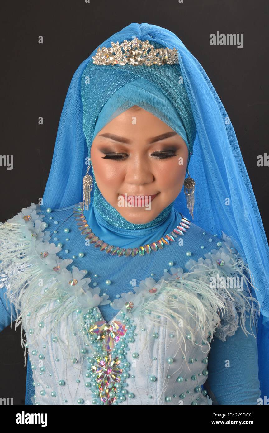 portrait of a beautiful muslim woman wearing a headscarf isolated on ...
