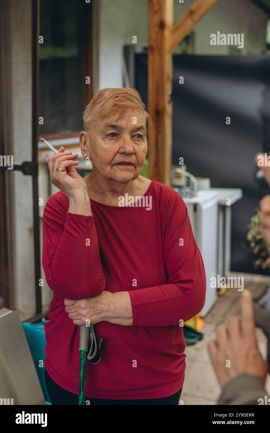 cigarette grandma Old grandma smoking a cigarette at home. High quality photo Stock Photo
