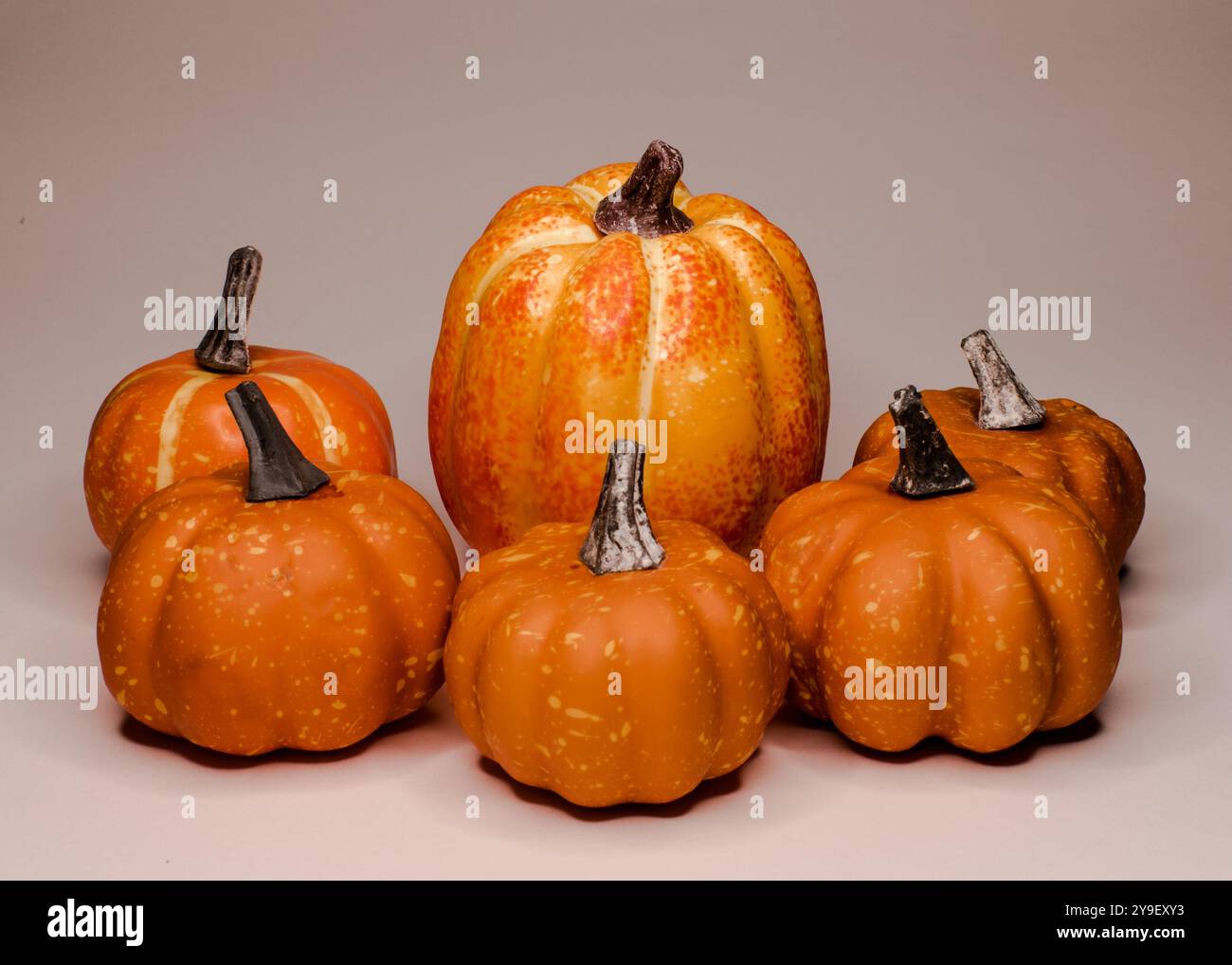 Group of small artificial pumpkins decorations on a bright background