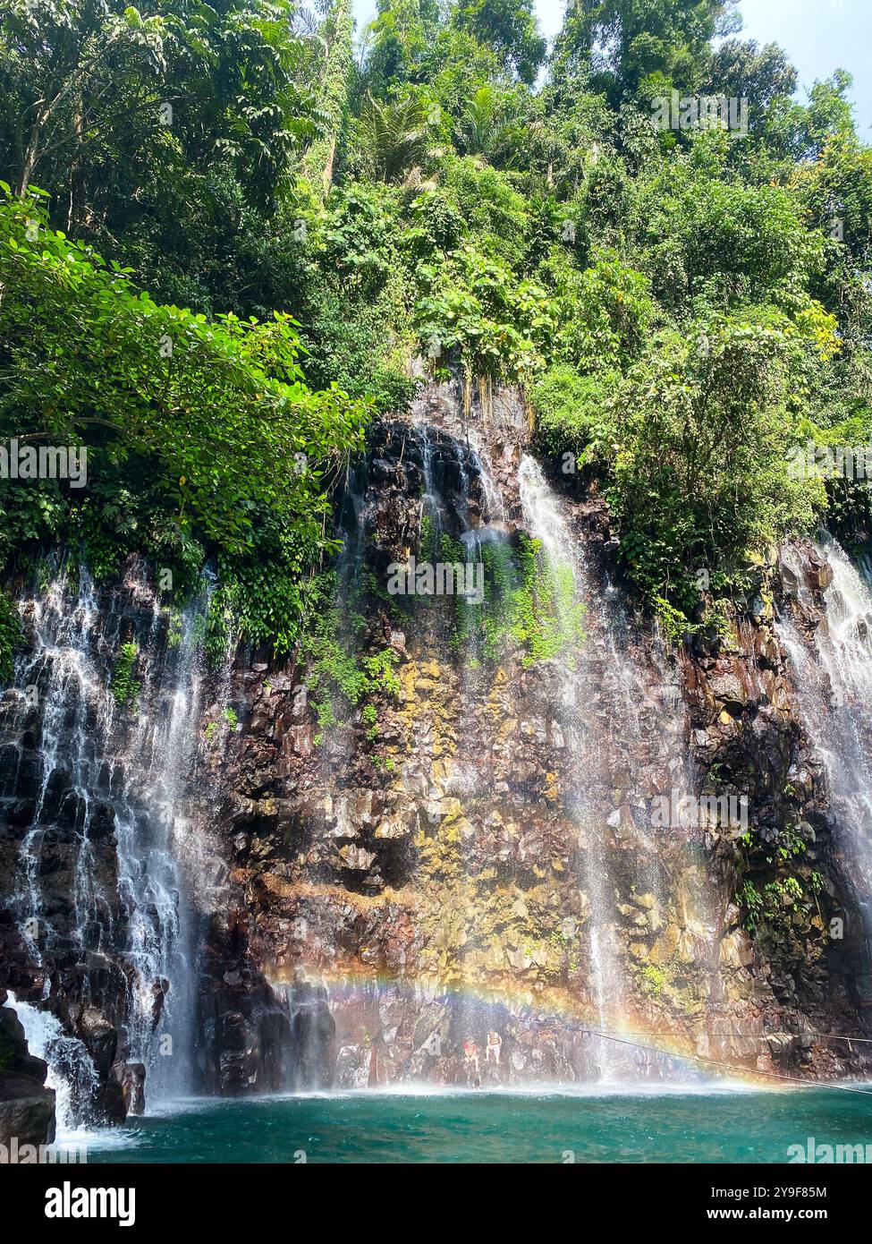 Tinago Falls with rainbow and green plunge pool. Lanao del Norte. Philippines. Stock Photo