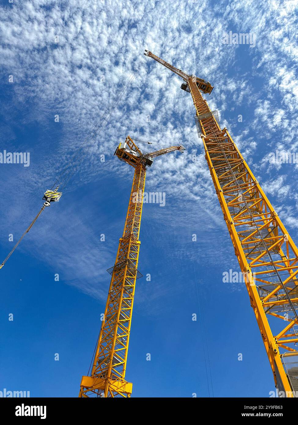 Cardiff, Wales UK - 16 August 2024: Wide angle view of tower cranes on a construction site in cardiff city centre - Smartphone Captured Stock Image