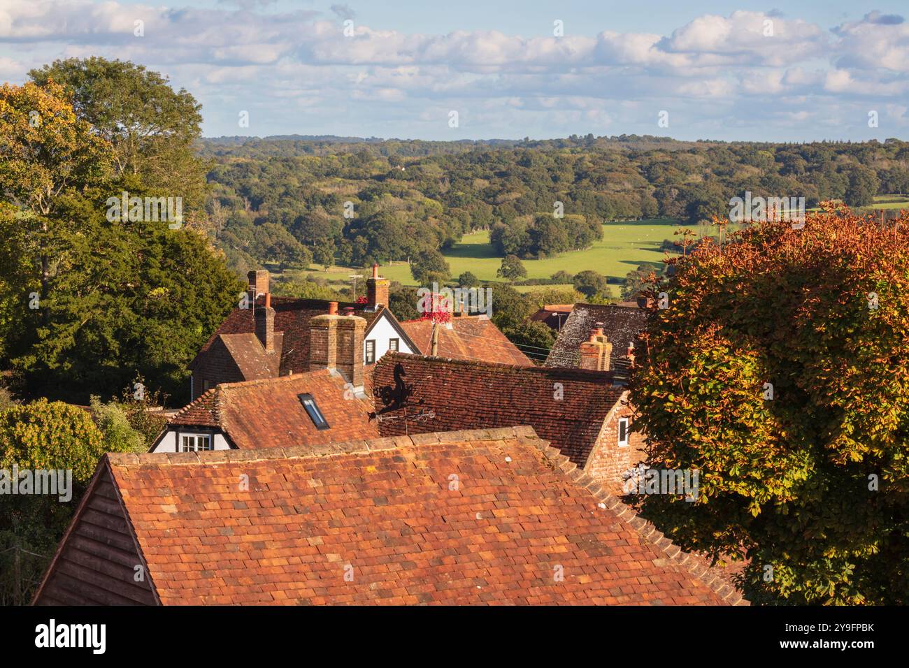 View of High Weald landscape behind village cottage rooftops, Burwash, East Sussex, England, United Kingdom, Europe Stock Photo