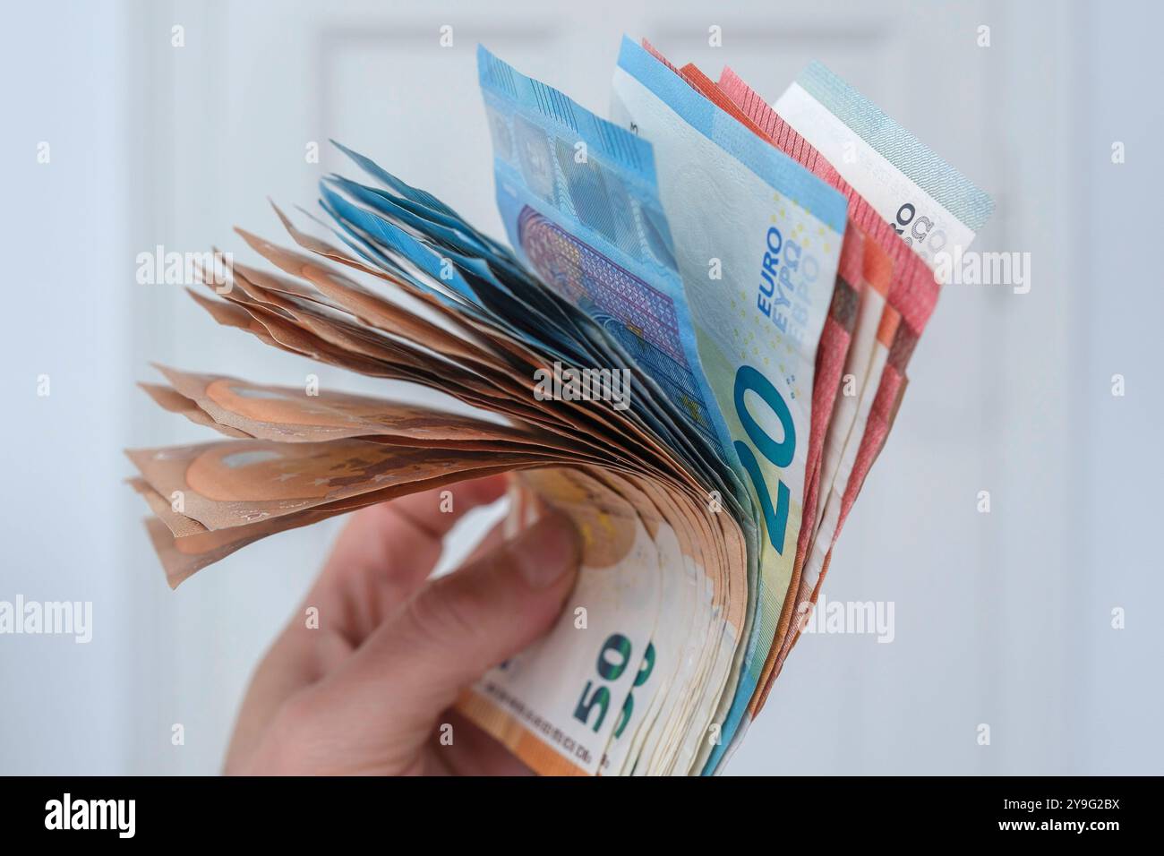 Hand with Euro notes Stock Photo
