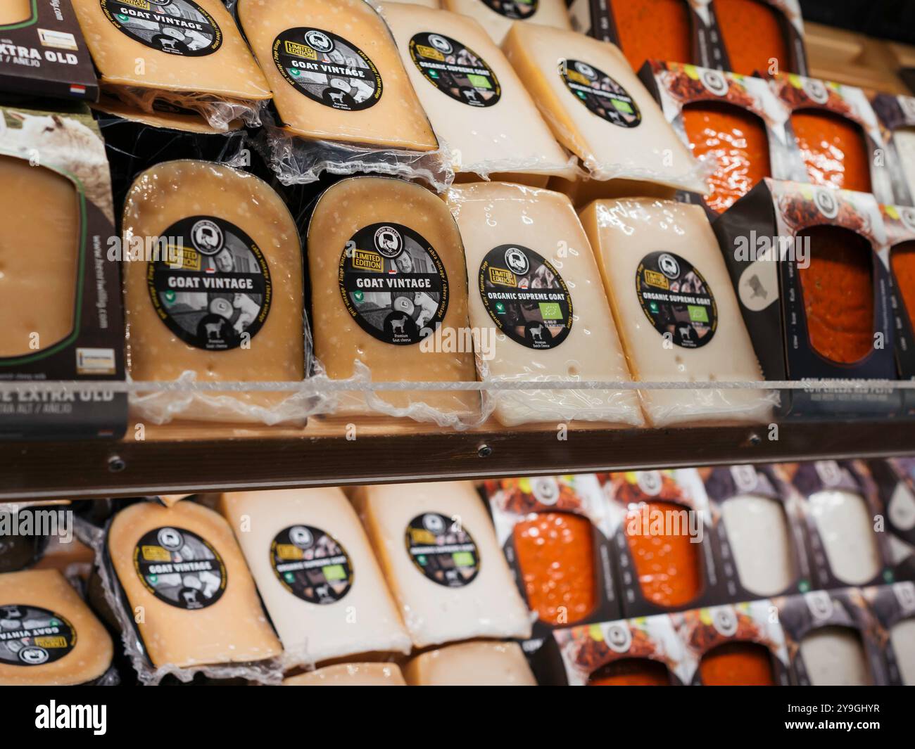 Dutch cheese shop. A rack with cheese of different types. Stock Photo