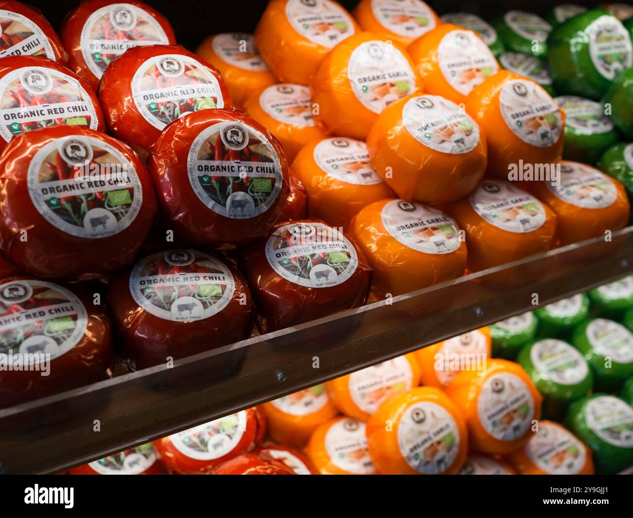 Dutch cheese shop. A rack with cheese of different types. Stock Photo