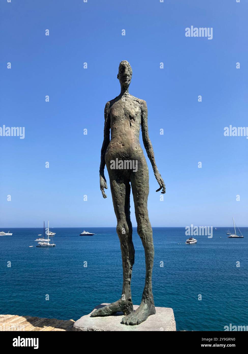 Sculpture Le Grain by Germaine Richier on the terrace of the Picasso Museum against a blue sky, Antibes, France - Smartphone Captured Stock Image