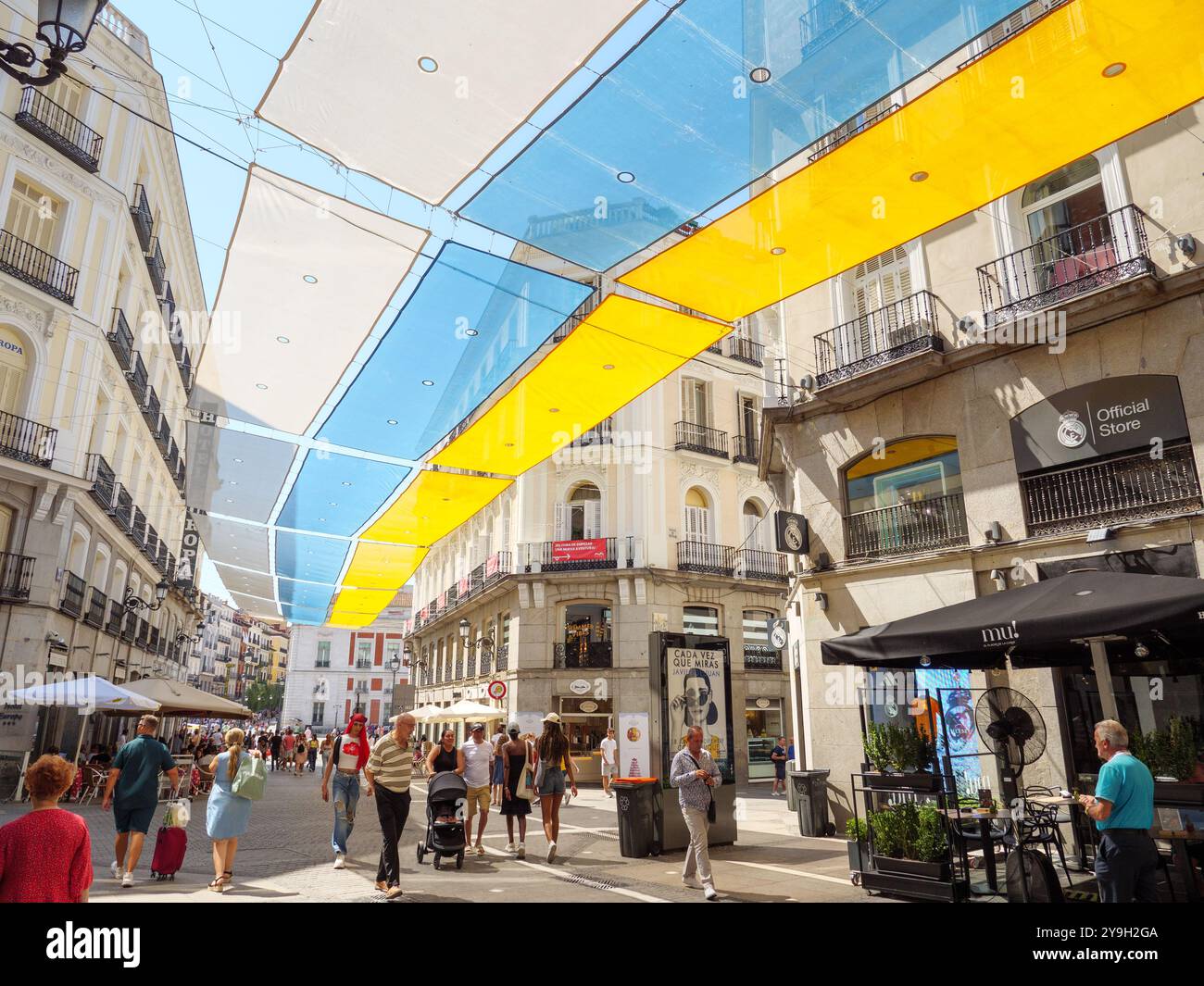 People walking down the city centre street of Calle del Carmen, Madrid, Spain Stock Photo