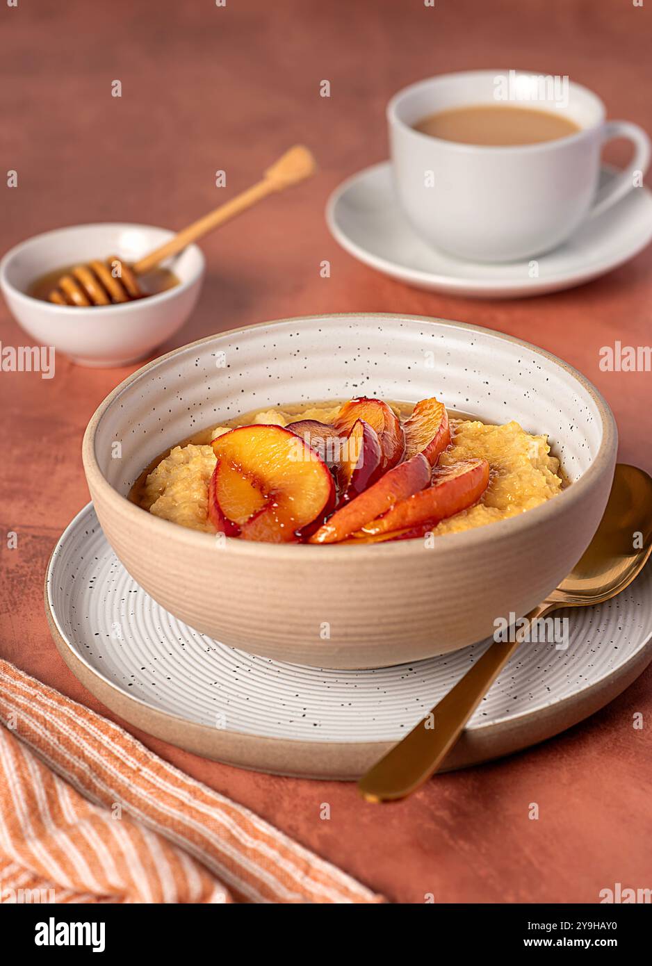 Food photography of millet porridge with caramelized peach, nectarine ...