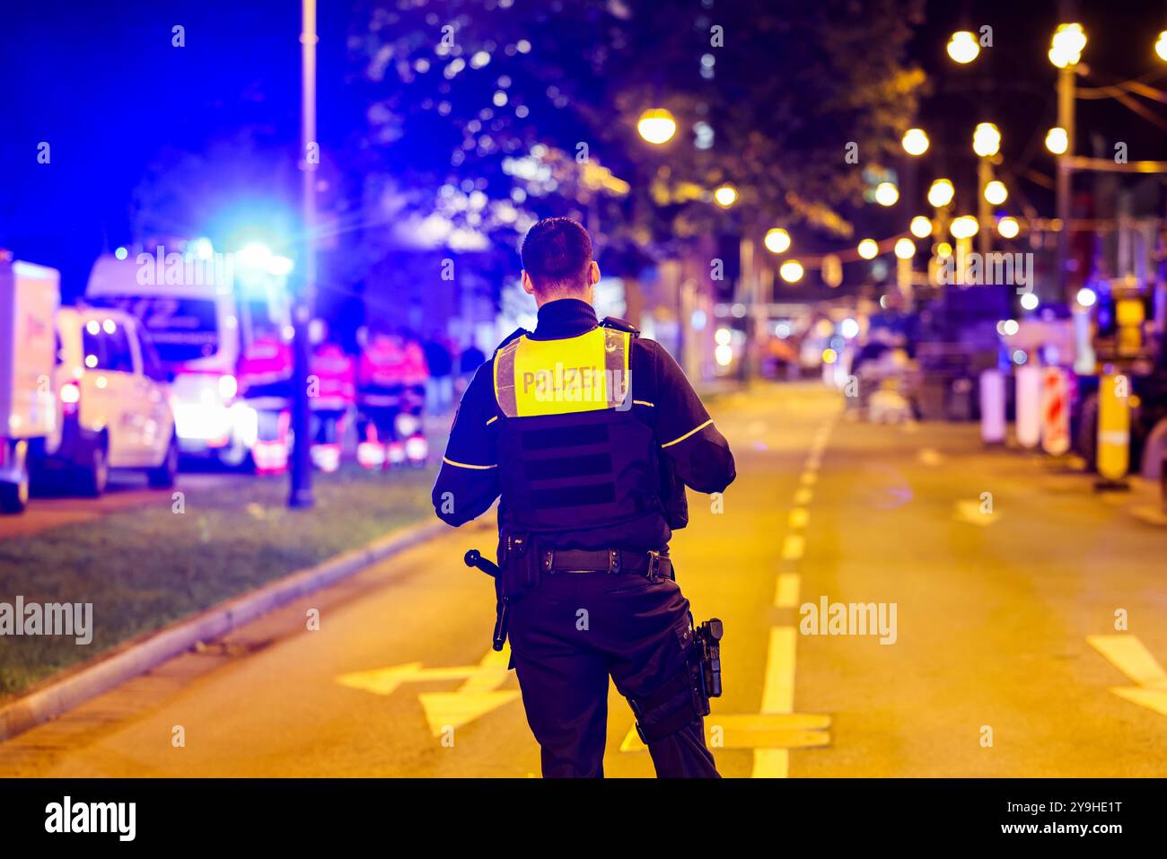 Krefeld, Germany. 10th Oct, 2024. A police officer secures the area in front of the Mulitplex movie theater where police gunned down a suspect. The man was injured, a spokesman said. The spokesman did not want to say what the suspect was allegedly doing. Credit: Christoph Reichwein/dpa/Alamy Live News Stock Photo