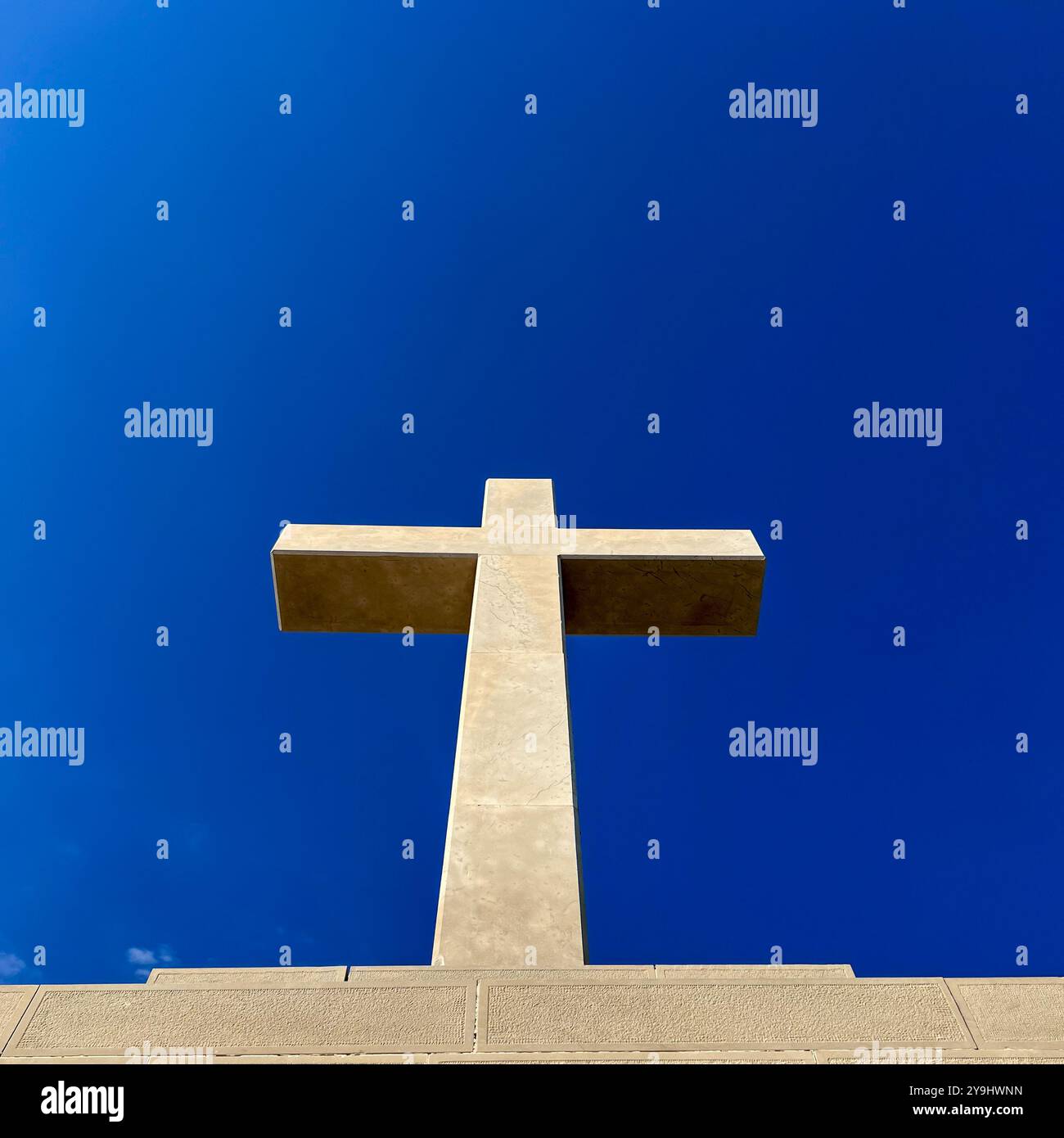 A large stone cross built on Srđ Hill, not far from the cable car station against a vivid blue sky. Dubrovnik, Croatia - Smartphone Captured Stock Image