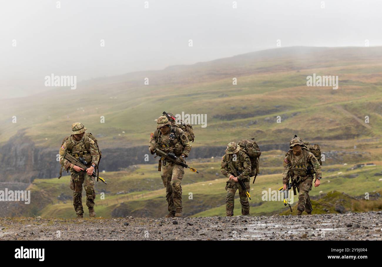 Army ROTC cadets from the Virginia Military Institute exit the CBRN stand at Exercise Cambrian Patrol on October 8, 2024, in Wales. The squad of eight VMI cadets became the first Army ROTC program to participate in NATO’s most challenging patrol test. | U.S. Army photo by Sarah Windmueller Stock Photo