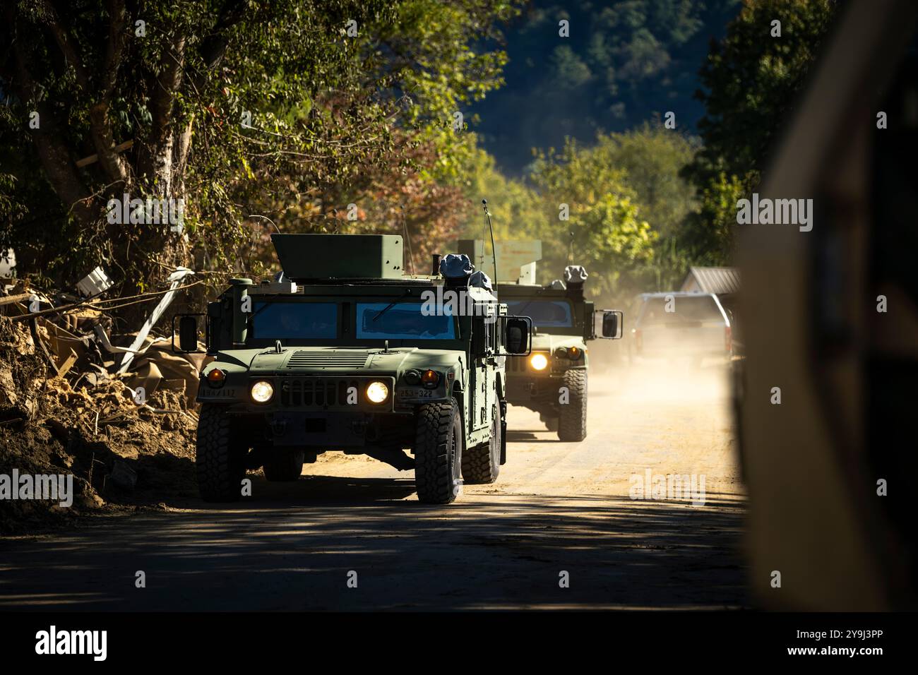U.S. Army National Guard humvees from the 194th Engineering Battalion Military Police patrol a job site in Erwin, Tennessee on Oct. 9, 2024. National Guard members were deployed from across Tennessee following flooding from Hurricane Helene to support local authorities with recovery efforts in the affected region (U.S. Air National Guard photo by Senior Airman Ben Cash) Stock Photo