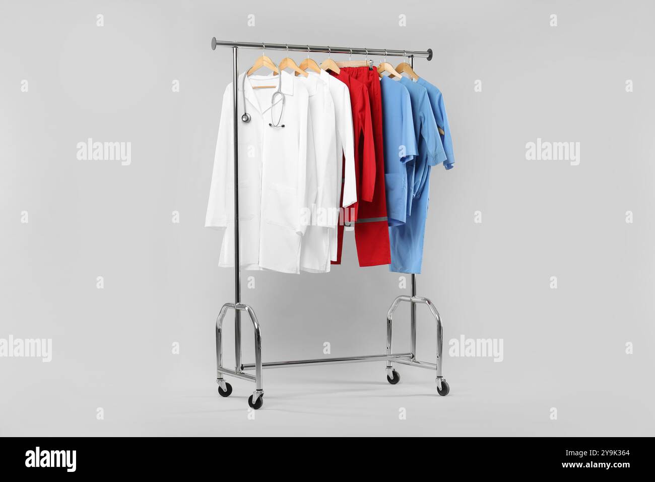 Medical Garment Rack Different medical workers' uniforms and stethoscope on clothing rack ...