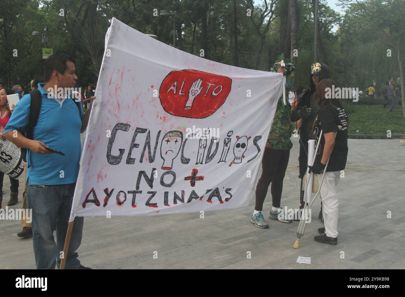 Mexico City, México: 04 26 2015; People protesting for the 43 teachers of Ayotzinapa missing. The cartel says 'stop genocides, no more ayotzinapas'. Stock Photo